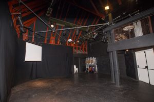 Image of small, empty theatre with full lighting rig.