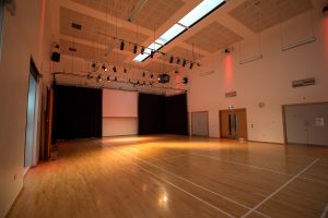 Large hall with lighting rig and wooden floor